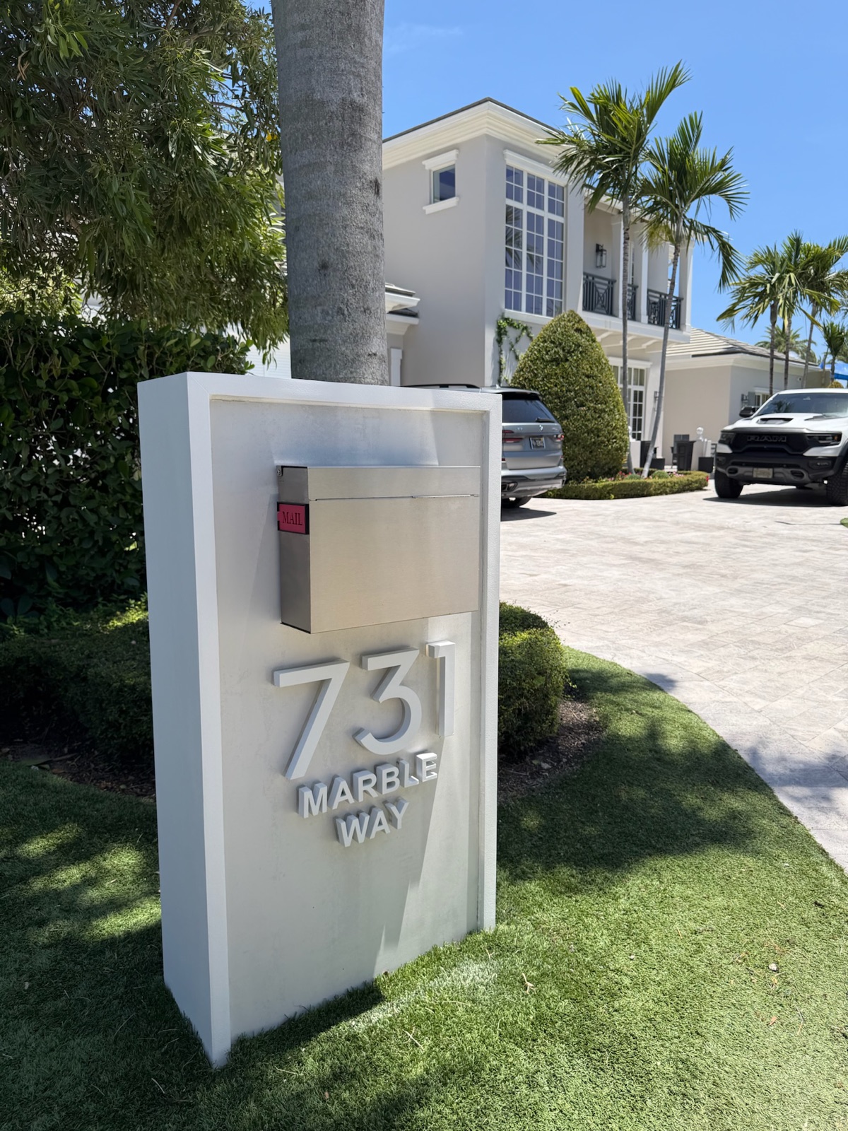 A community mailbox and post installed with a finished rock bed at the base