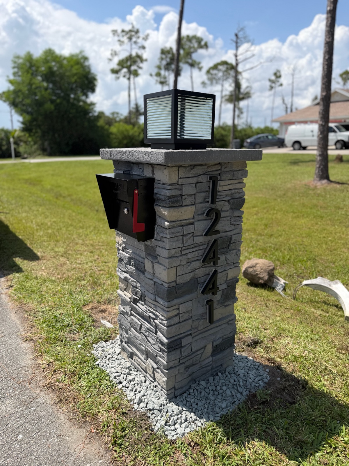 A community mailbox unit and post photographed at the curb for a bid comparison