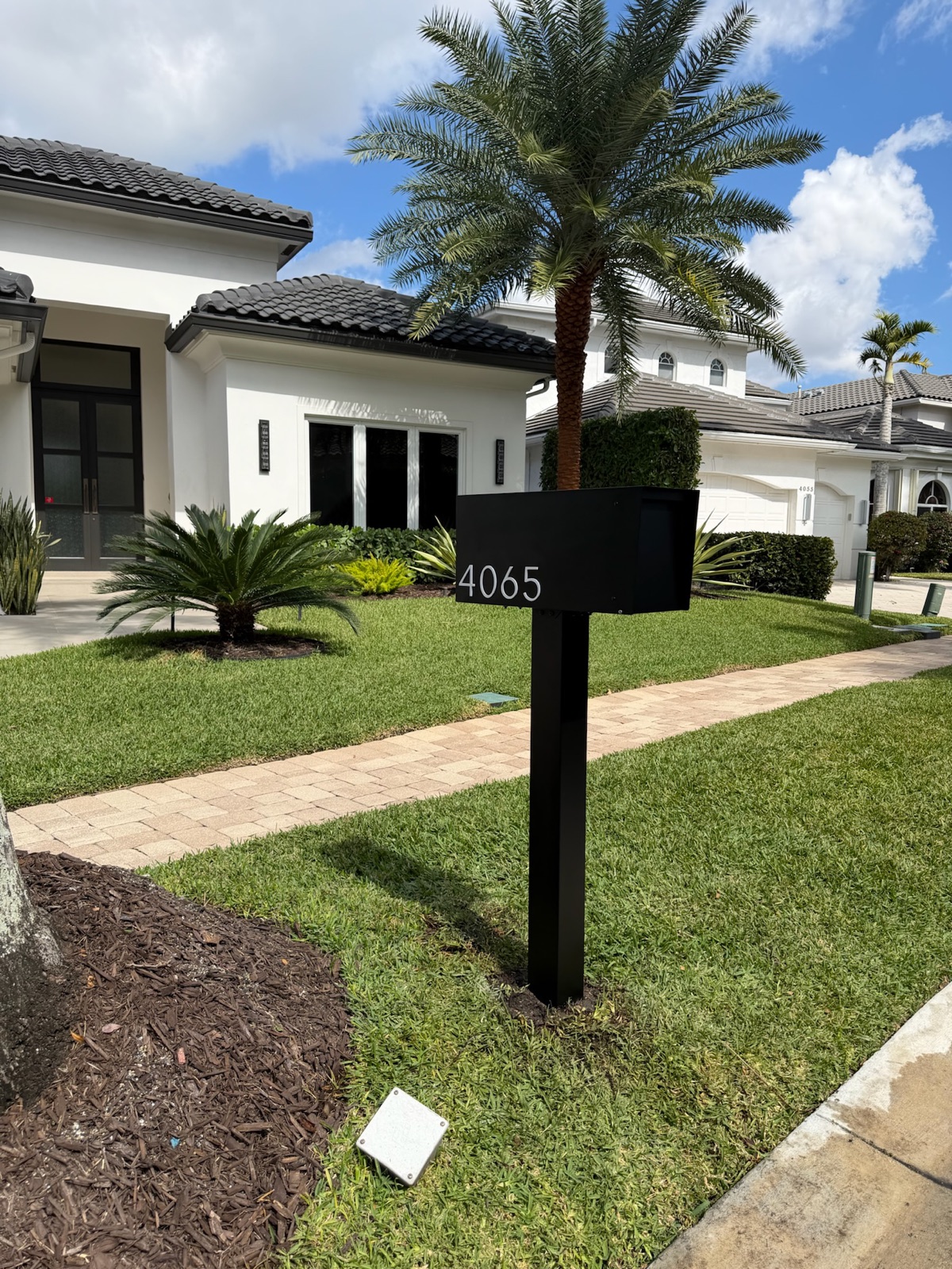A custom mailbox and post detail showing finish, address numbers, and base