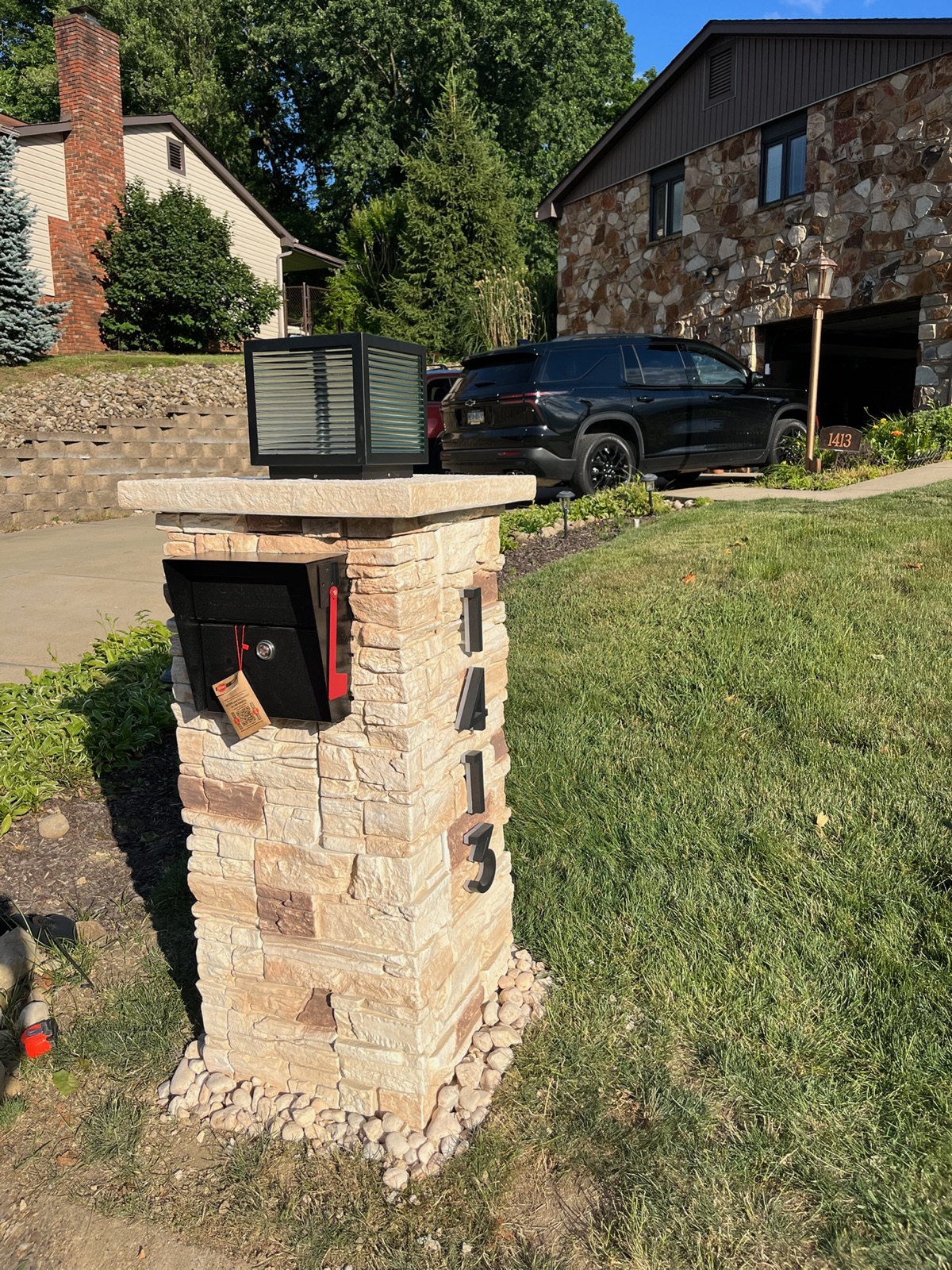 A custom community mailbox with the house number, matched to an approved color palette