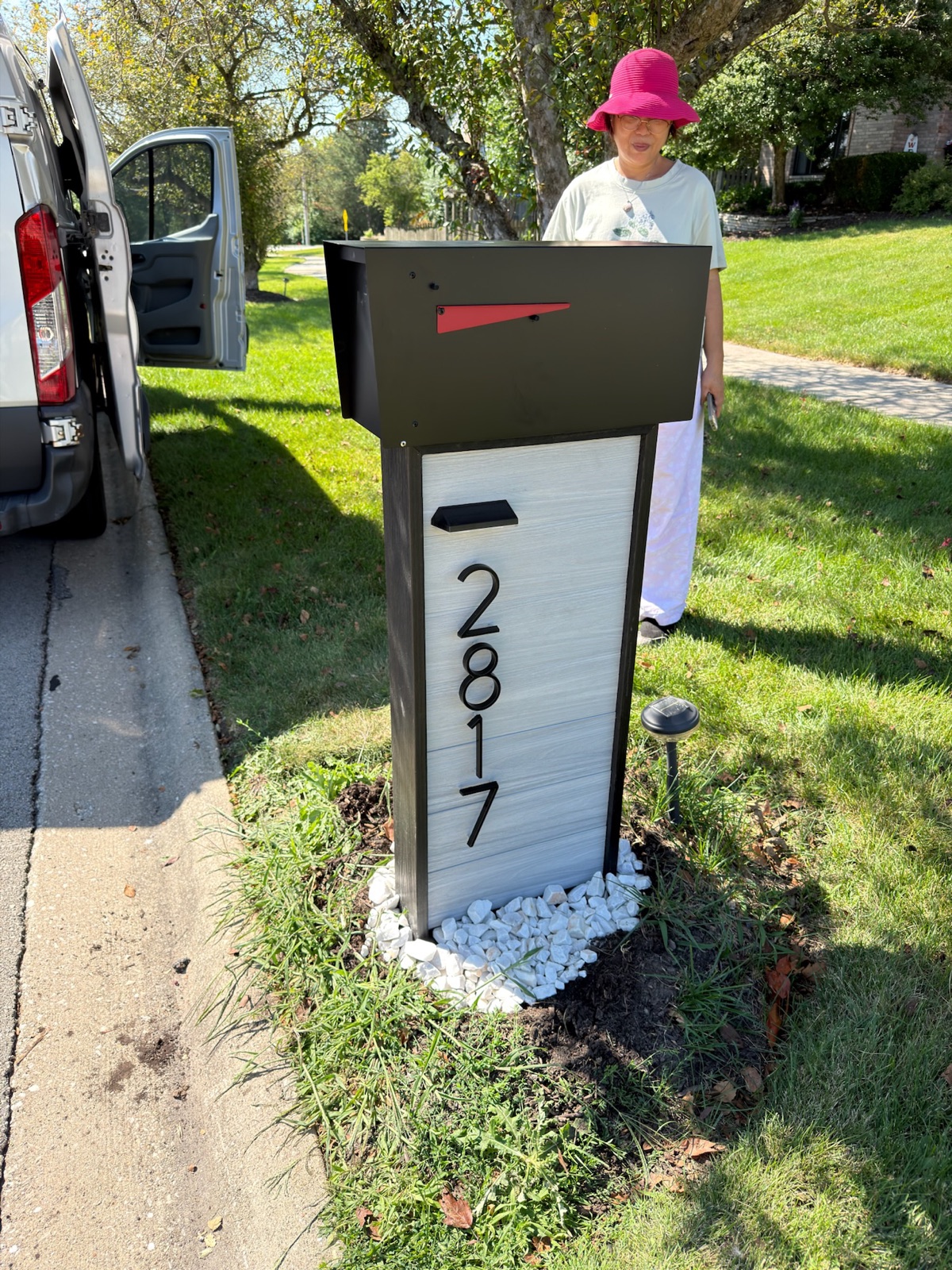 A mailbox post being set in concrete at the correct curbside height and setback