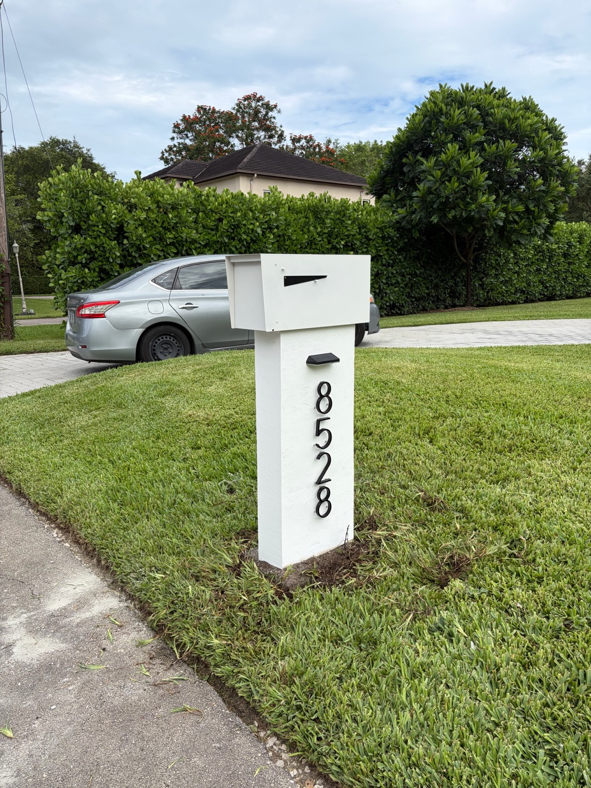 House numbers on a custom mailbox, sized and finished for legibility from the street