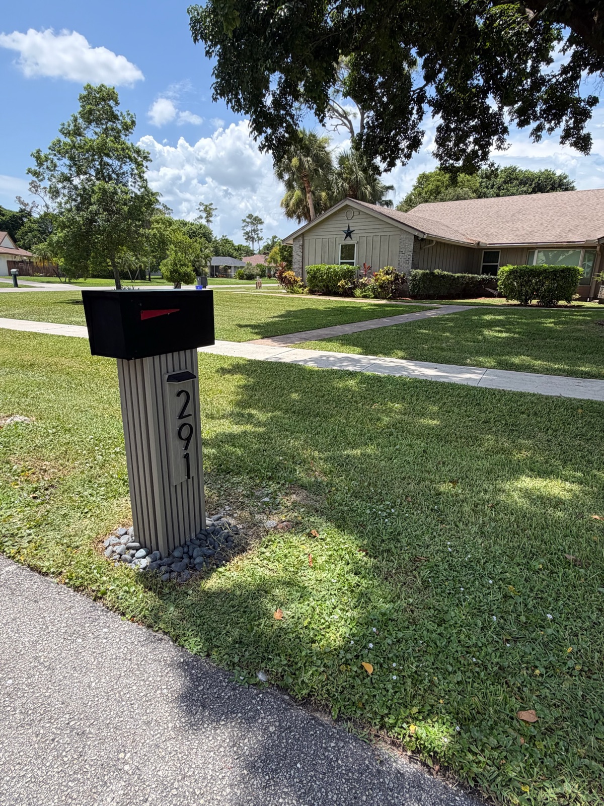 Matching custom mailboxes set along the curb in a newly built Florida community