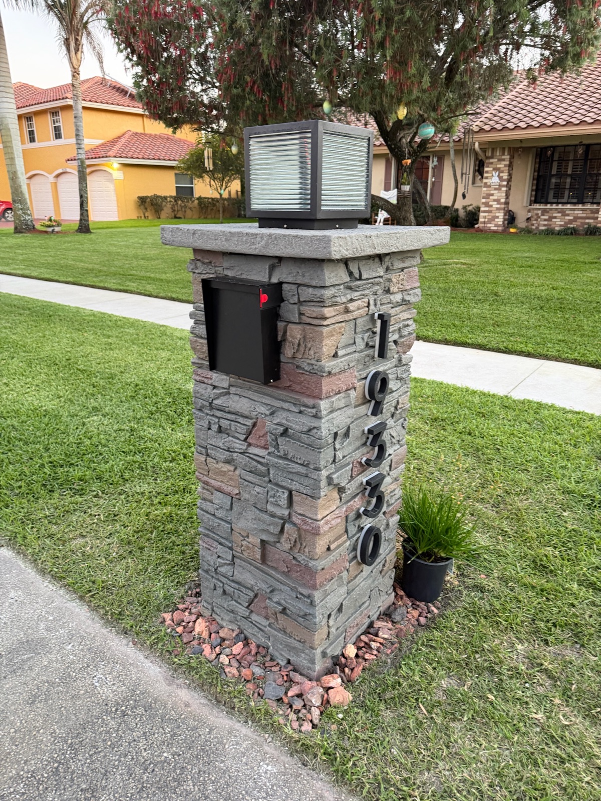 A custom locking mailbox in a white and black finish matched to a community standard