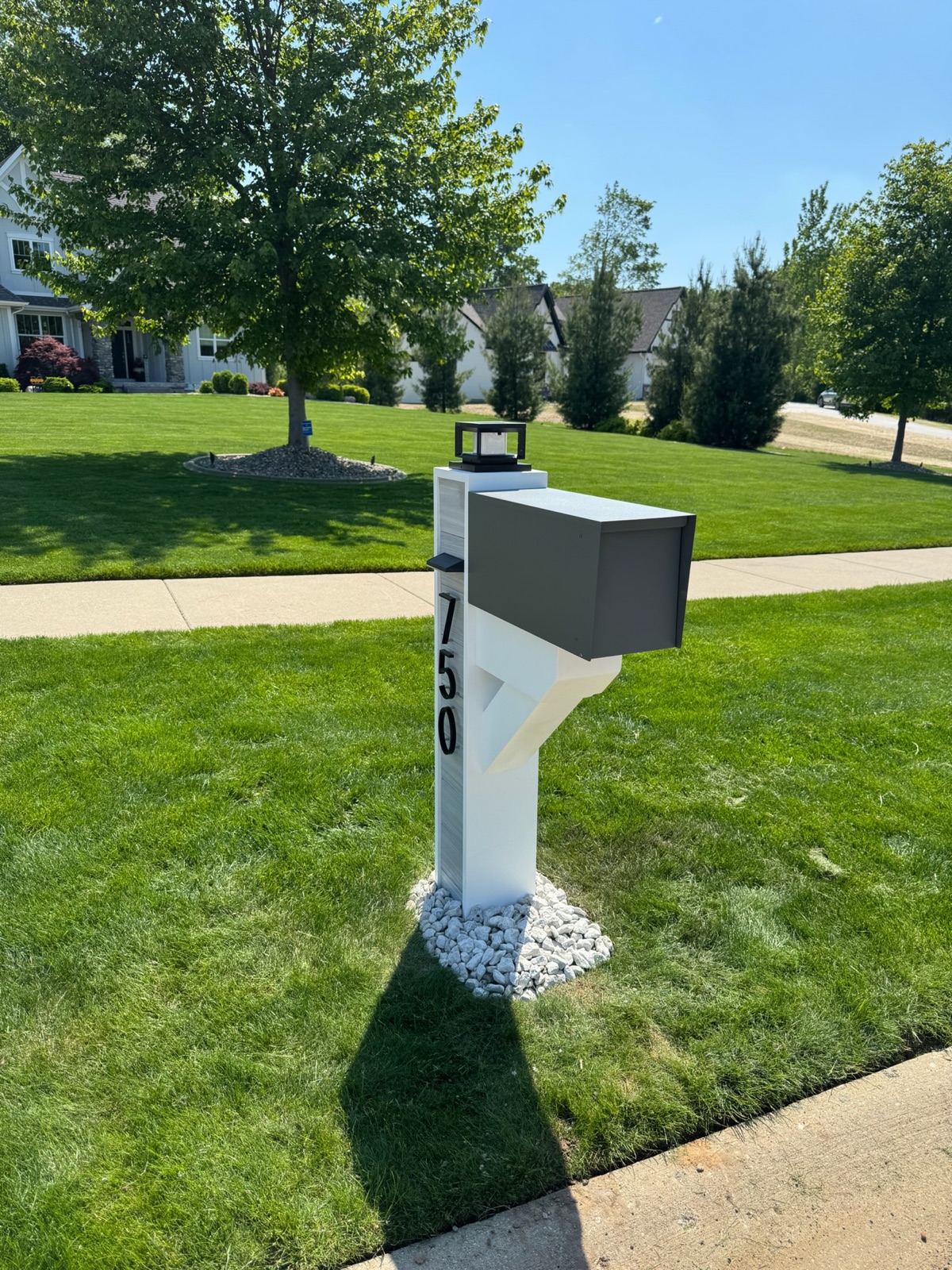 A black modern-farmhouse composite mailbox set at the curb of an Atlanta-area home