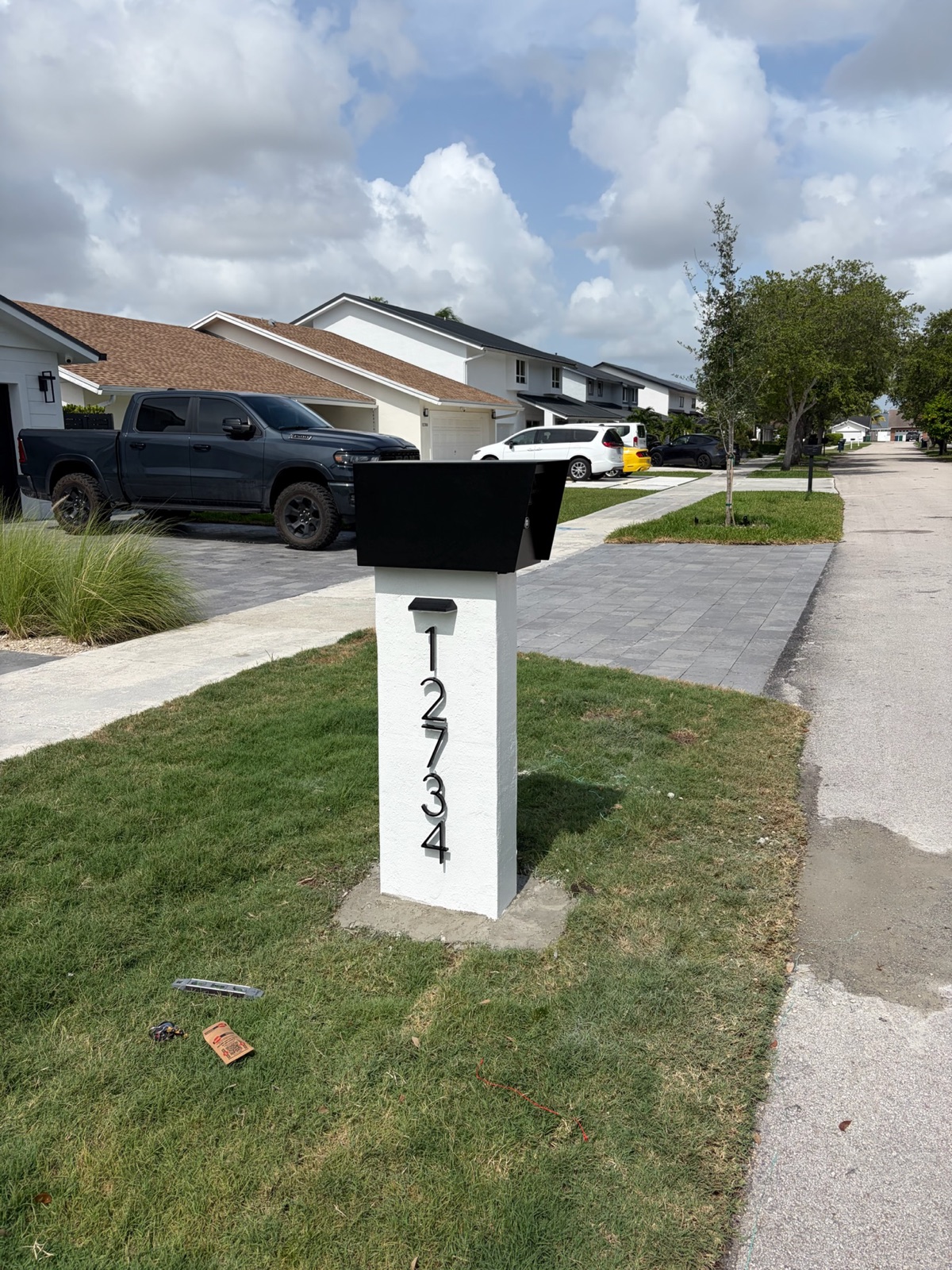 A black Slatline aluminum custom mailbox set at the curb in front of a Dallas-Fort Worth home