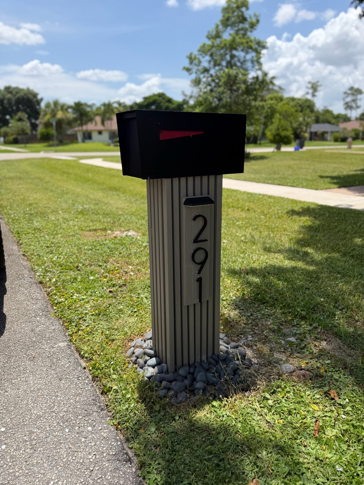 A custom rust-proof mailbox set at the curb of a waterfront home in the Fort Lauderdale area