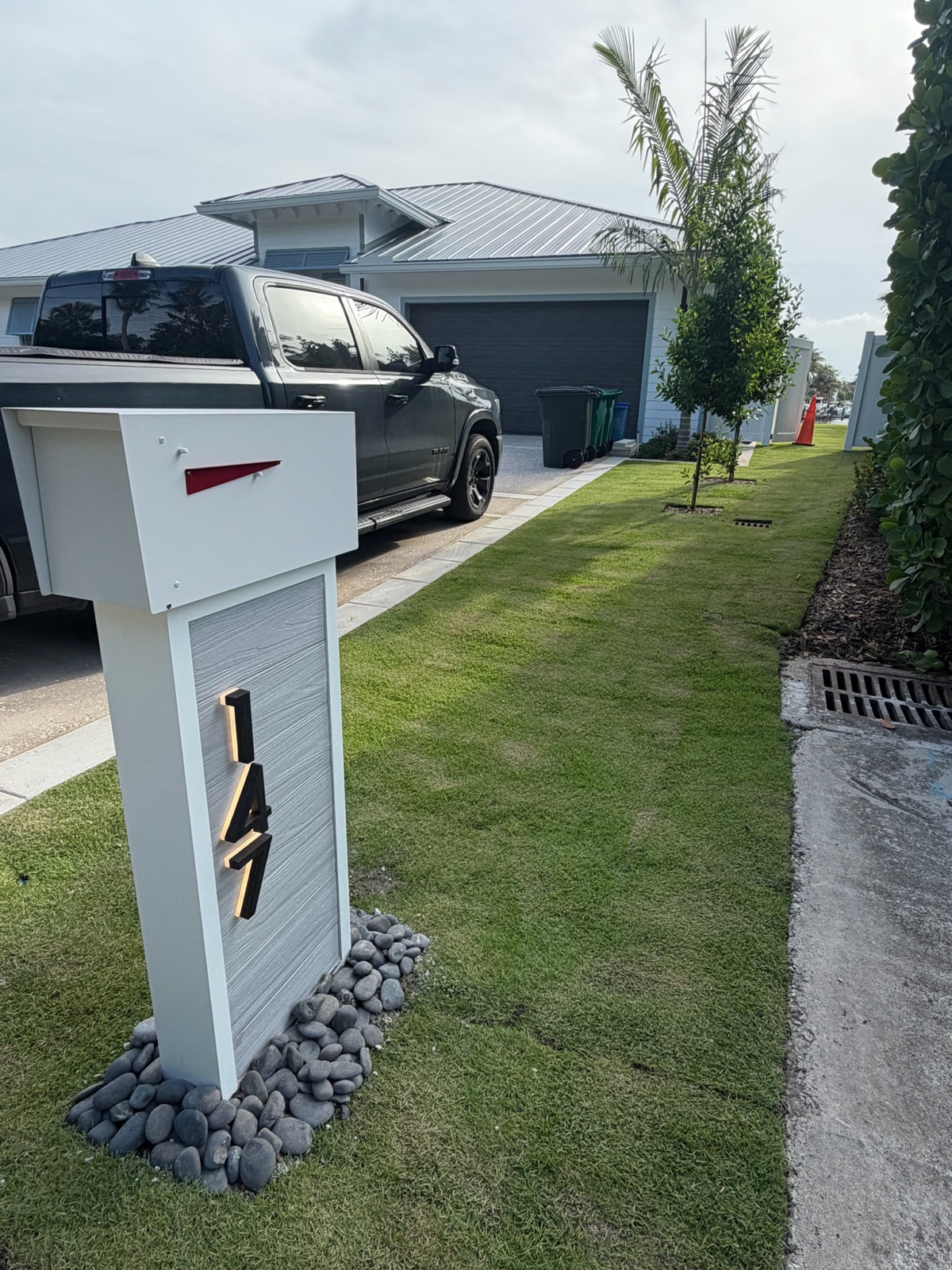 A modern farmhouse composite mailbox in white and walnut set at the curb of a Los Angeles area home