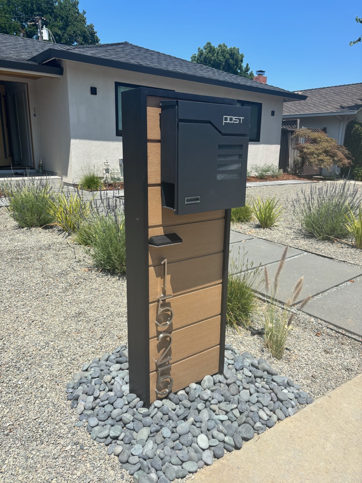 A white Slatline aluminum custom mailbox set at the curb outside a desert-contemporary home