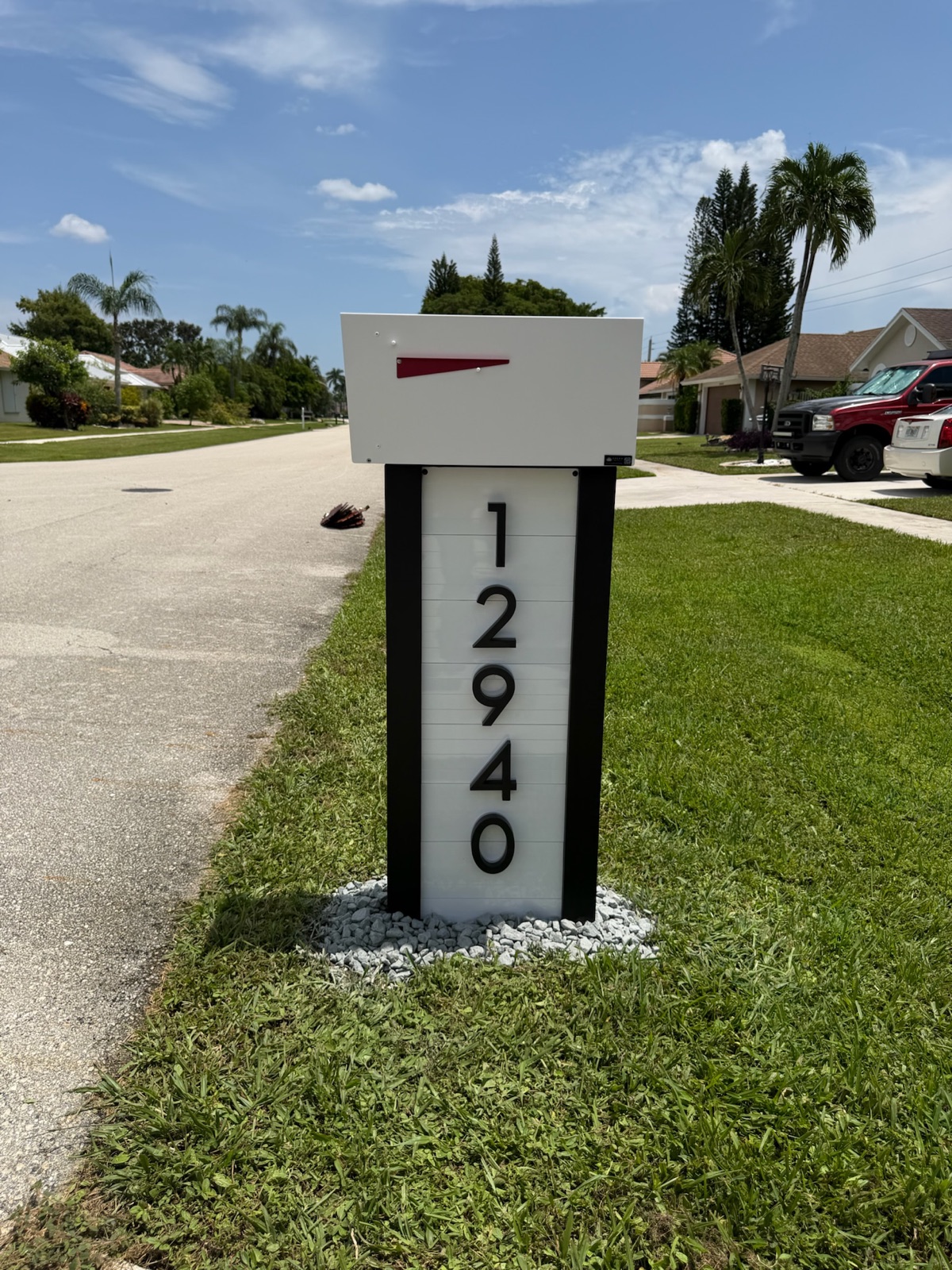 A custom mailbox set at the curb of a Scottsdale desert home under bright sun