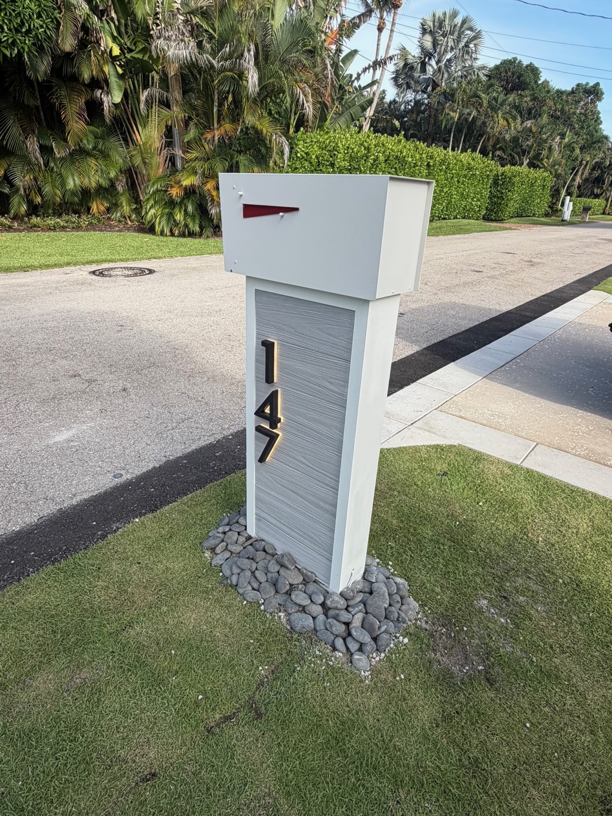 A row of matching custom community mailboxes set along a residential street