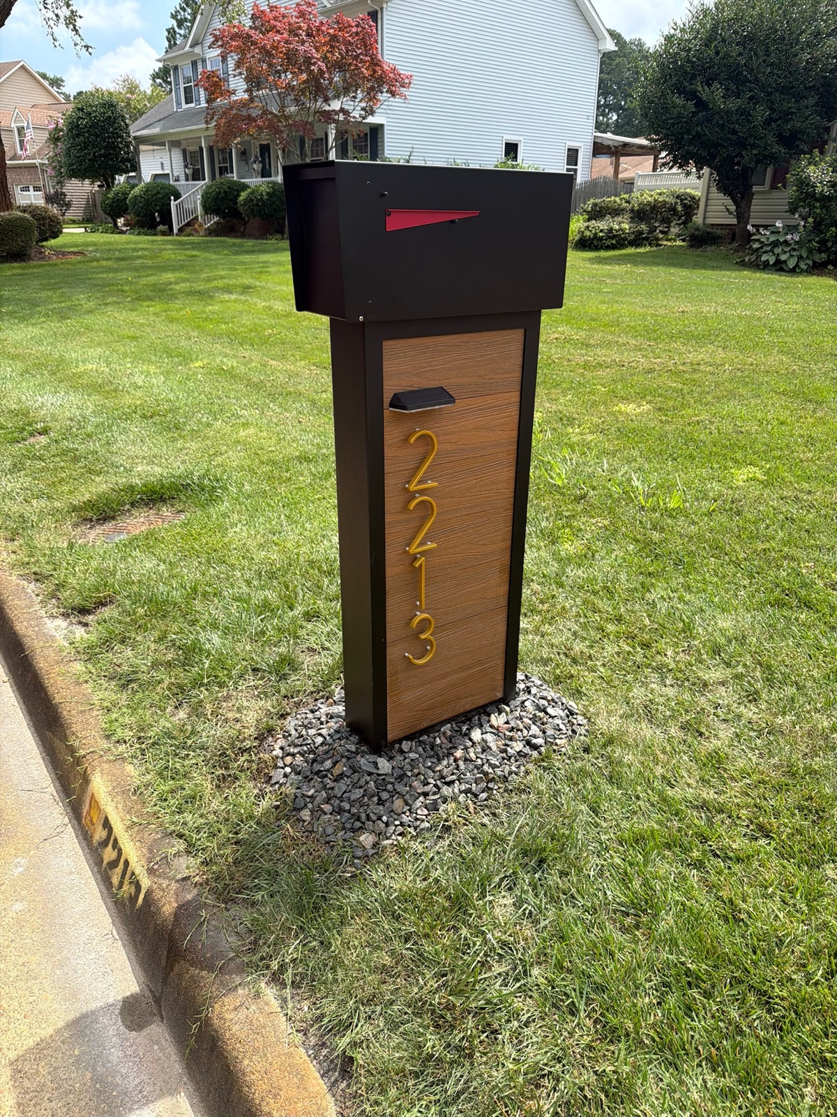 Matching custom mailboxes installed along a residential street in a managed community