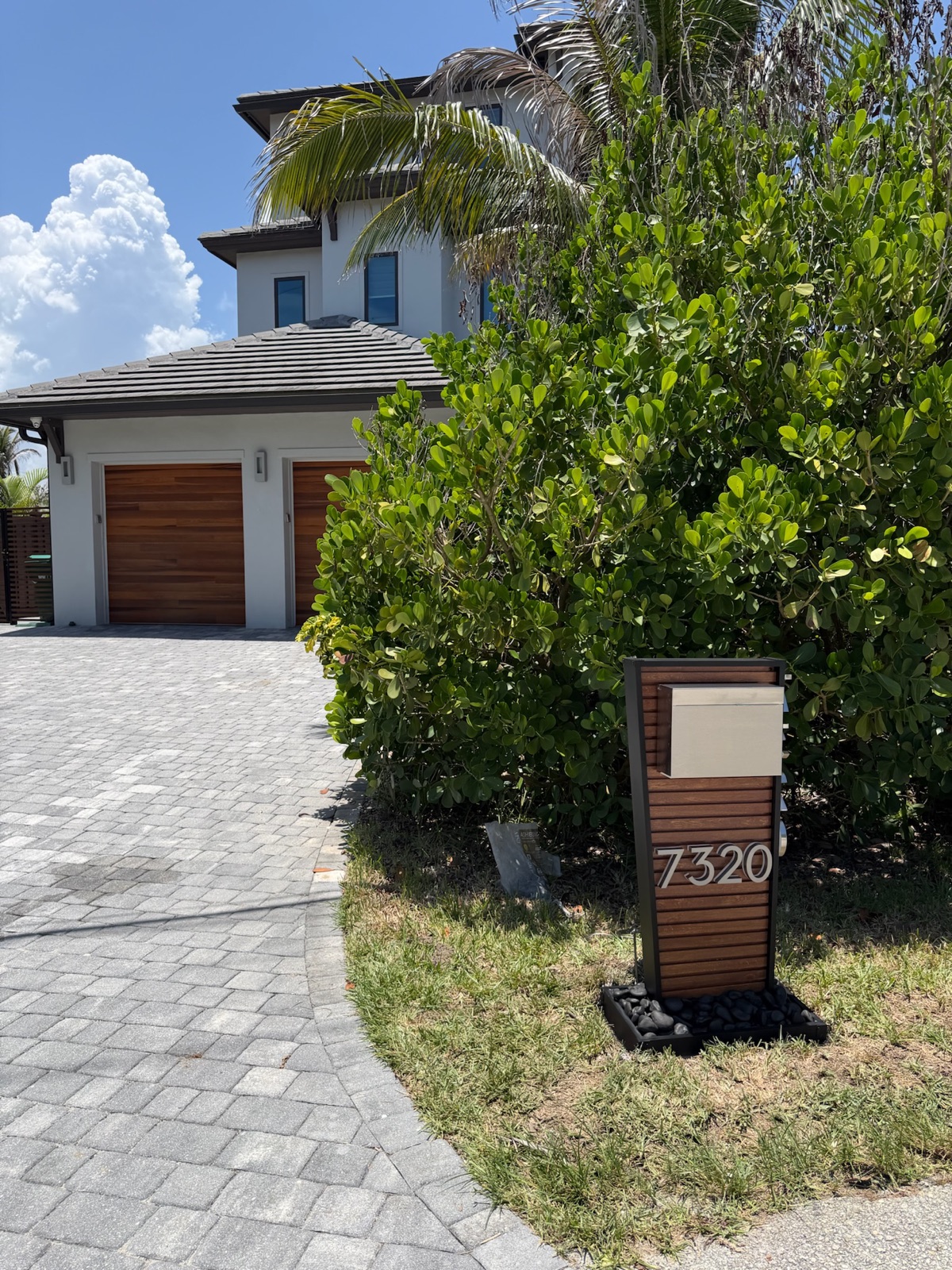 A row of matching custom mailboxes along a community street, set at a consistent height and setback