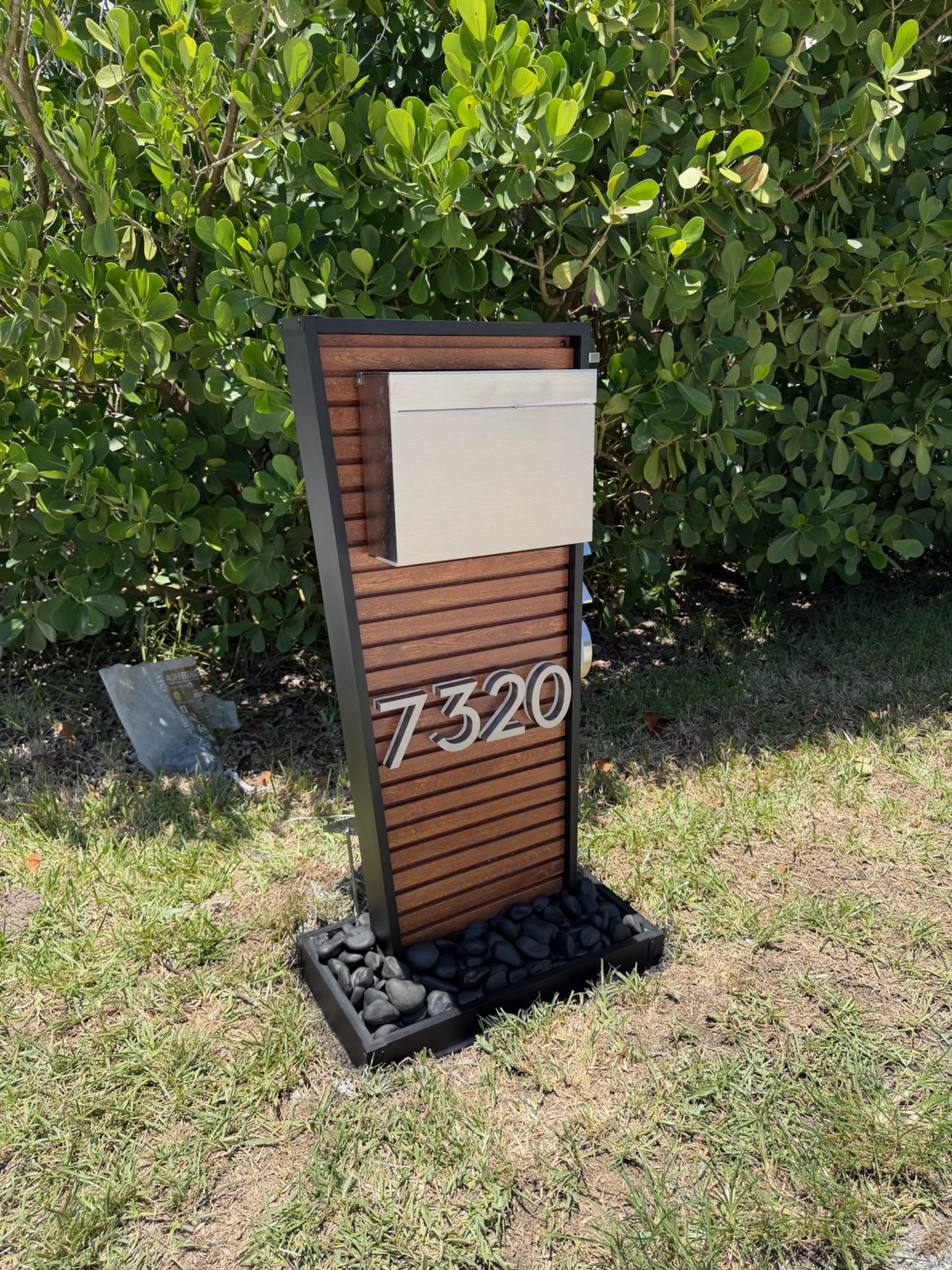 A custom community mailbox with the address numbers and finish matched to the neighborhood palette