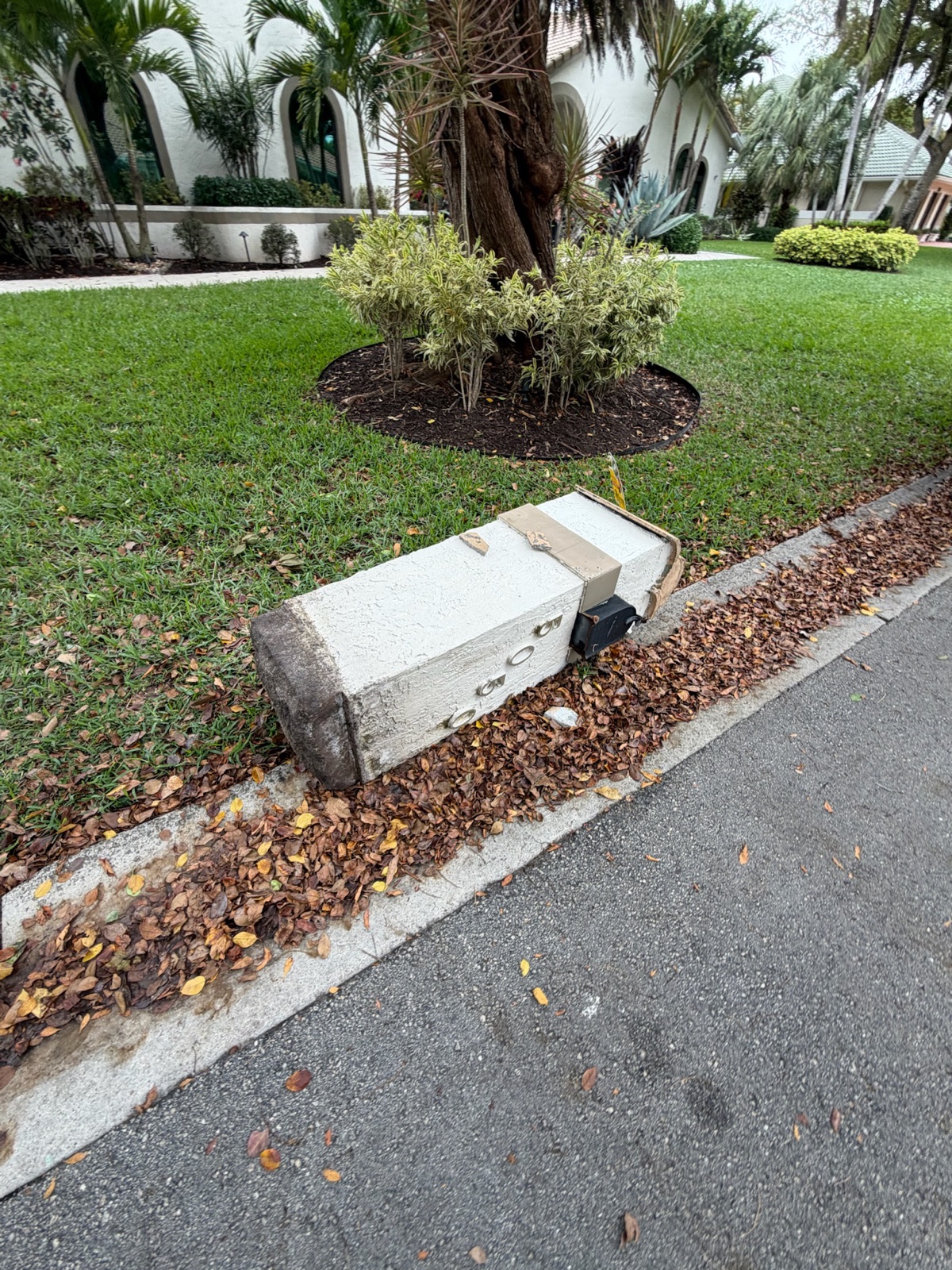 A hand-built custom mailbox set at the curb in front of a home
