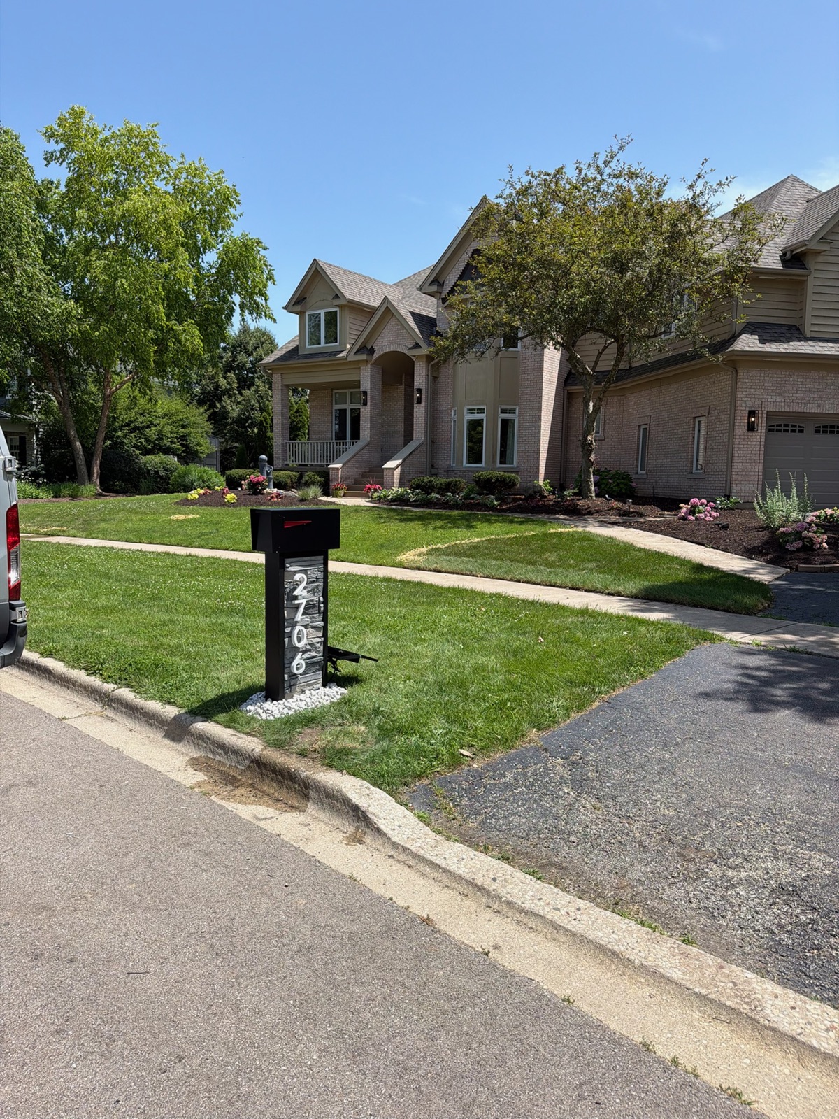 A custom community mailbox and post shown as an approved design specification